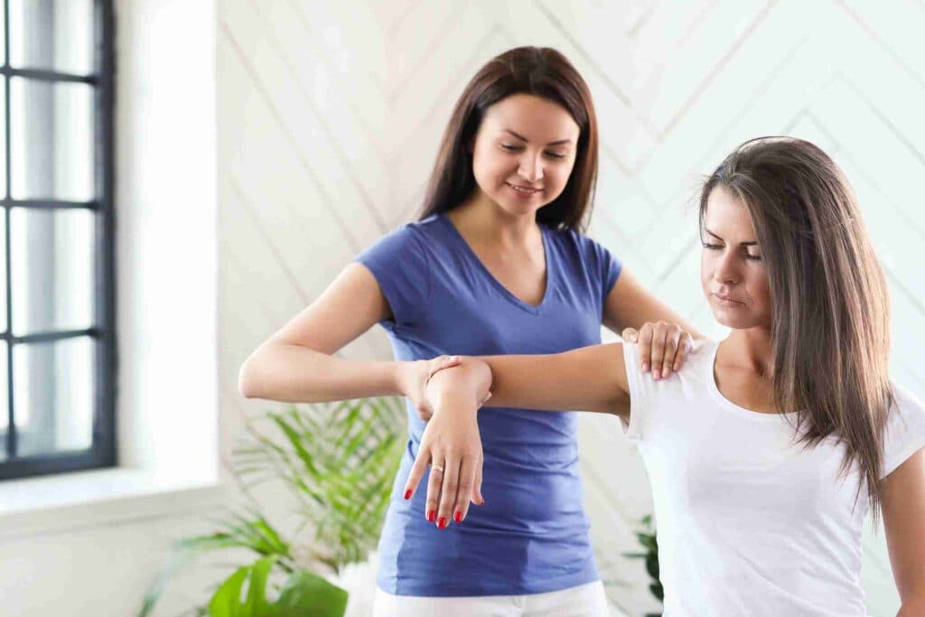Woman is getting physical therapy from a professional doctor